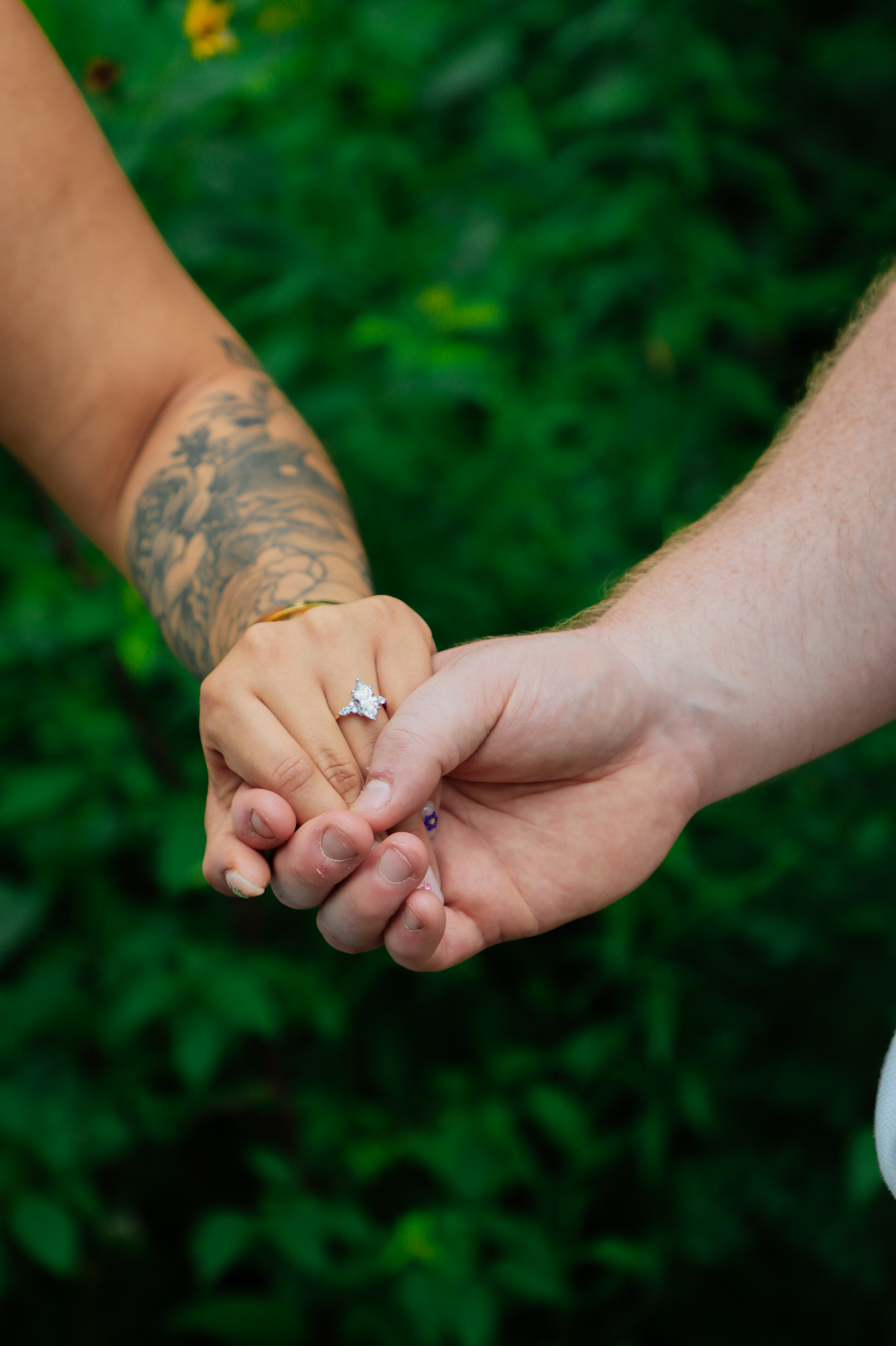 Hands together showing an engagement ring
